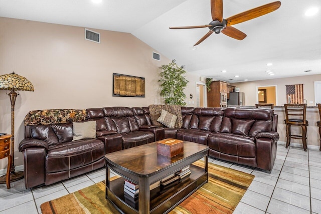 living room with vaulted ceiling, ceiling fan, and light tile floors