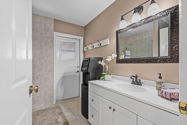 bathroom with tile floors, vanity with extensive cabinet space, and tile walls