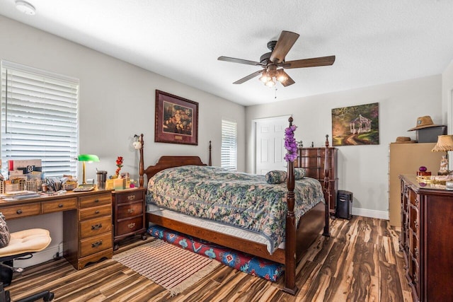 bedroom featuring ceiling fan, a textured ceiling, and dark wood-type flooring