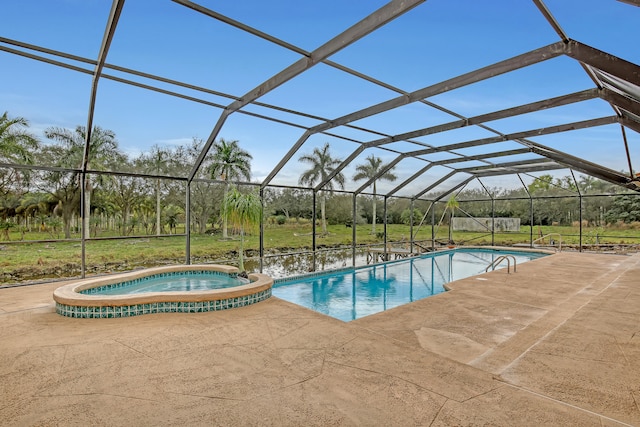 view of pool featuring an in ground hot tub, glass enclosure, and a patio area