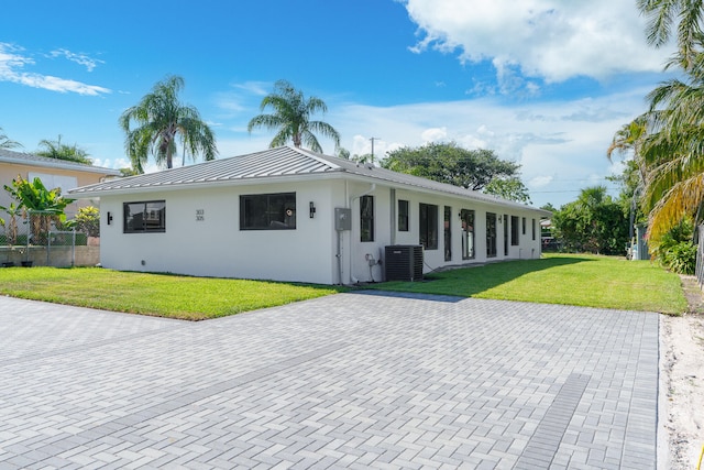 ranch-style house with central AC and a front lawn