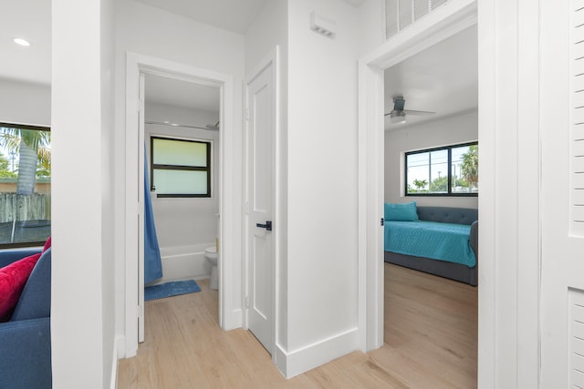 hallway with light hardwood / wood-style flooring