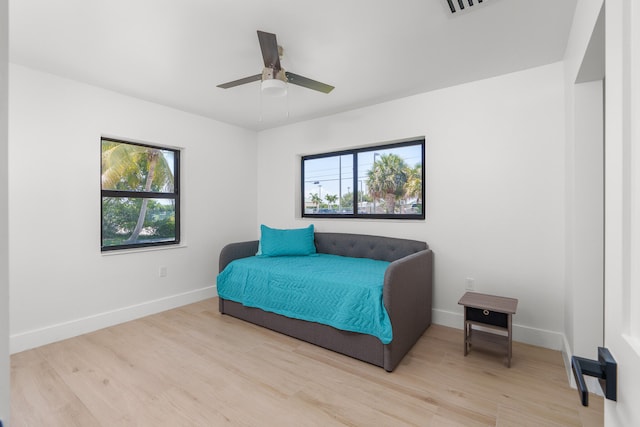 bedroom with ceiling fan and light wood-type flooring