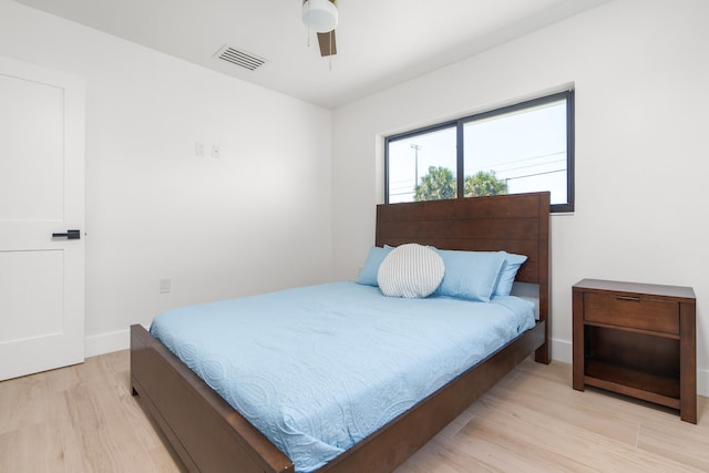 bedroom with ceiling fan and light wood-type flooring