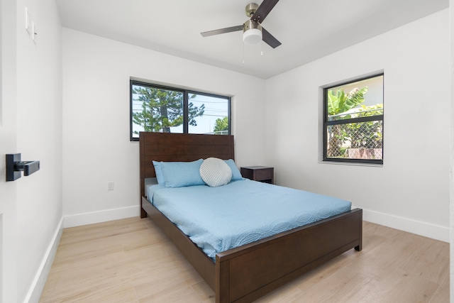 bedroom with ceiling fan and light hardwood / wood-style flooring