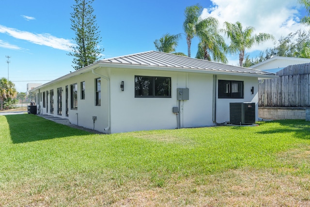 view of home's exterior featuring a lawn and central air condition unit