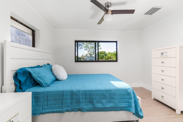 bedroom with ceiling fan and light wood-type flooring