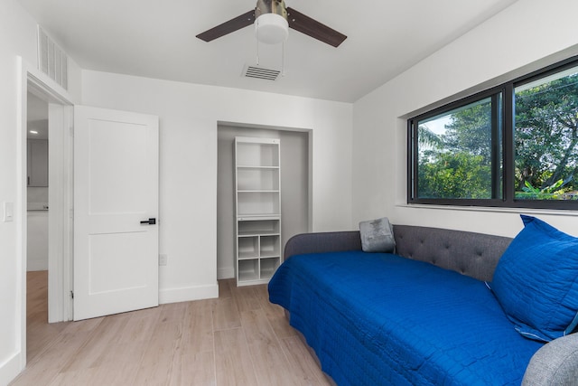 bedroom with ceiling fan and light hardwood / wood-style flooring