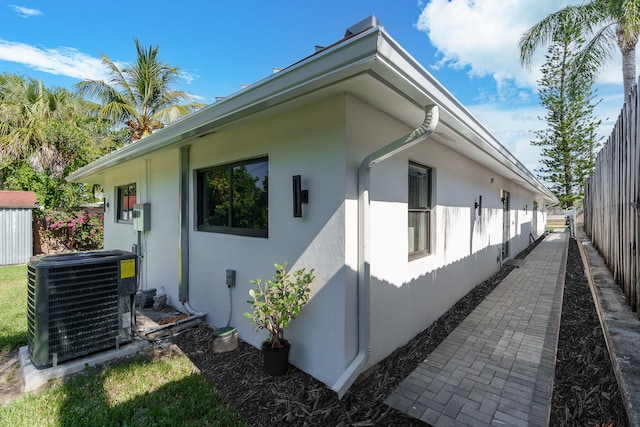 view of side of home with central air condition unit