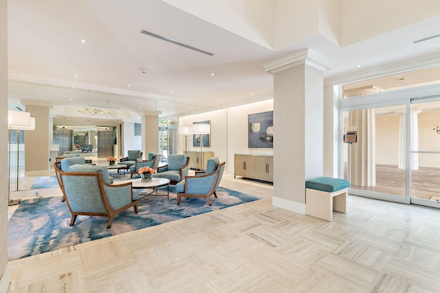 interior space featuring crown molding, decorative columns, and a wealth of natural light