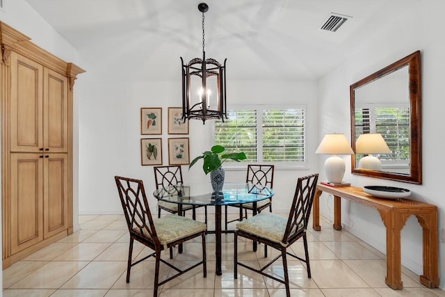 dining room with light tile patterned flooring and a chandelier