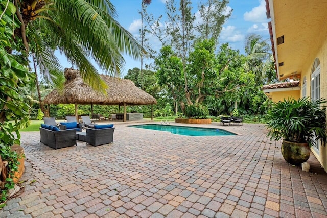 view of swimming pool with an outdoor living space, a gazebo, and a patio