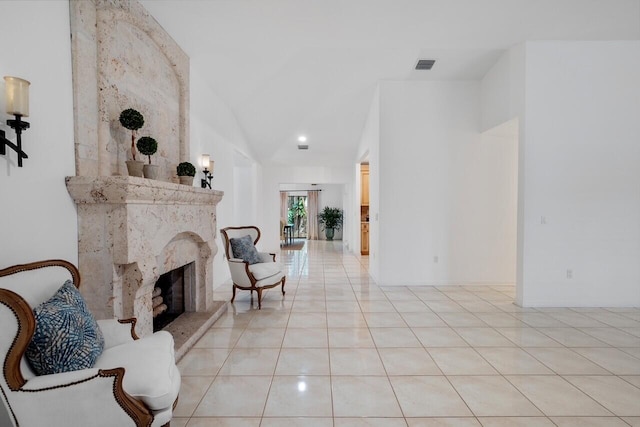 living area featuring light tile patterned floors and a high end fireplace