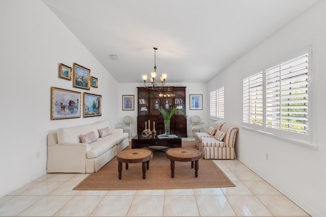 tiled living room with vaulted ceiling and a notable chandelier