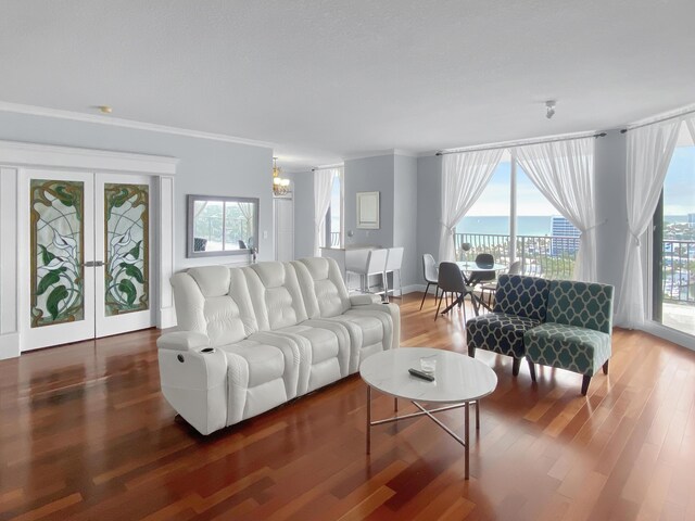 living room featuring crown molding, dark hardwood / wood-style floors, and a textured ceiling