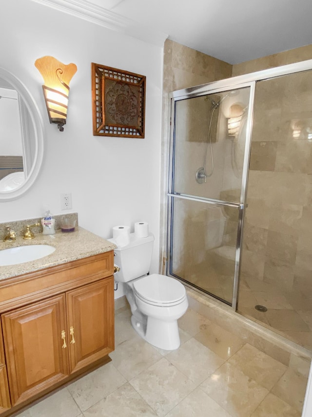 bathroom with a stall shower, vanity, and toilet