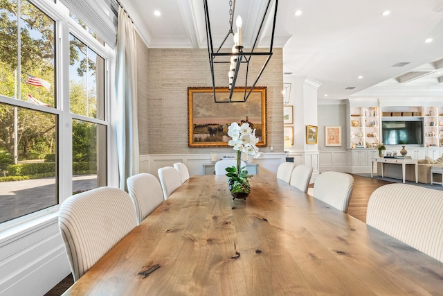 dining room with hardwood / wood-style flooring and ornamental molding