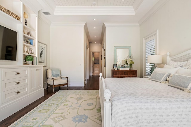 bedroom with dark hardwood / wood-style floors, a tray ceiling, and crown molding