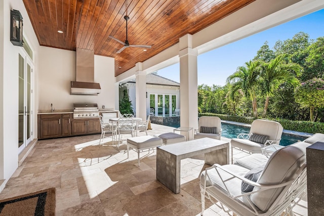 view of patio / terrace featuring ceiling fan, an outdoor kitchen, and a grill