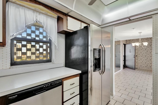 kitchen featuring white cabinetry, decorative light fixtures, an inviting chandelier, and appliances with stainless steel finishes