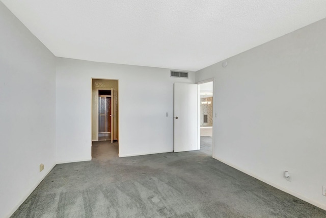 unfurnished room featuring carpet floors and a textured ceiling