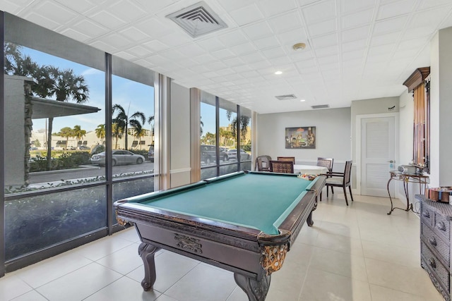 playroom with expansive windows, billiards, and light tile patterned flooring