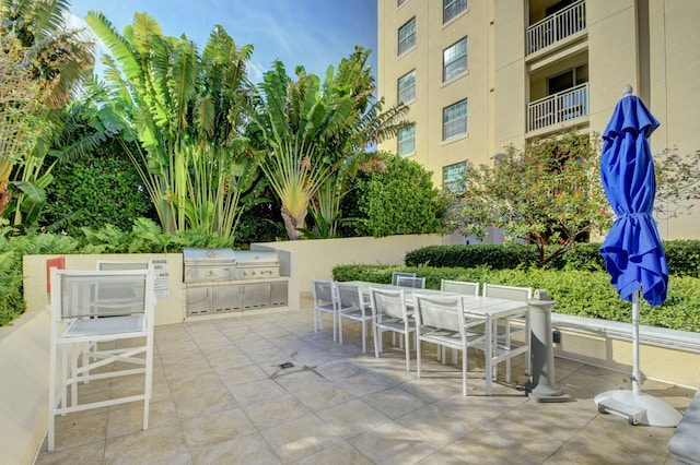 view of patio / terrace featuring a grill and a balcony