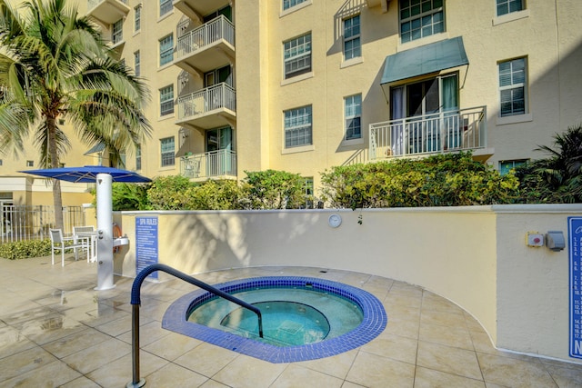 view of swimming pool with a patio area and a community hot tub