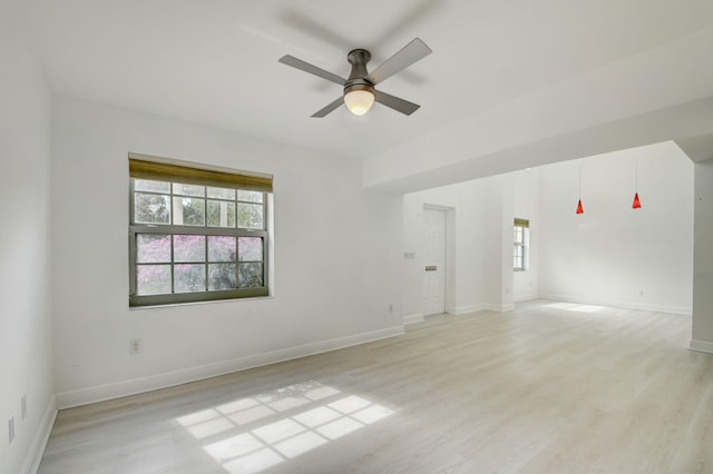 unfurnished room with light wood-type flooring and ceiling fan