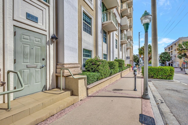 view of exterior entry featuring a balcony