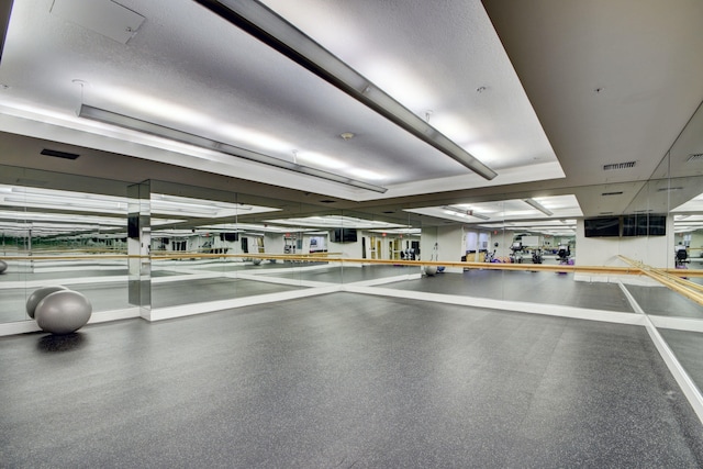 gym with a textured ceiling