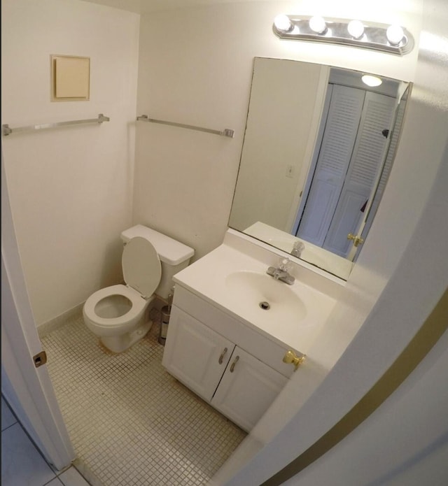 bathroom featuring tile flooring, large vanity, and toilet