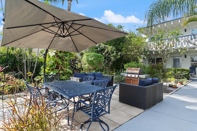 view of patio featuring a balcony and a grill