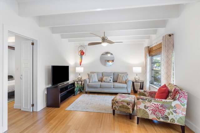 living room with ceiling fan, hardwood / wood-style flooring, and beamed ceiling