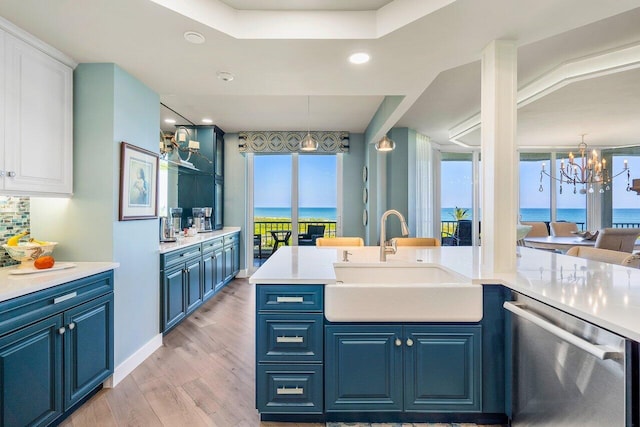 bathroom featuring a water view, large vanity, hardwood / wood-style floors, and an inviting chandelier