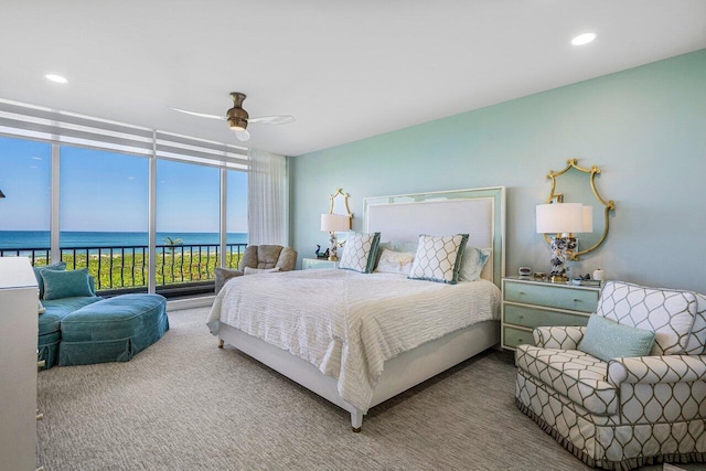 carpeted bedroom featuring a water view, ceiling fan, and access to outside