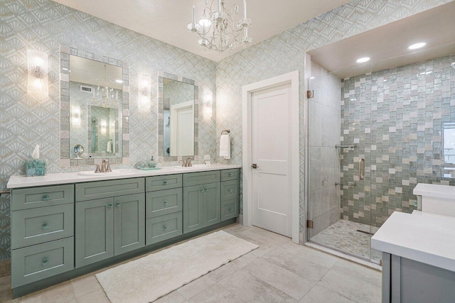 bathroom featuring a chandelier, dual vanity, walk in shower, tile walls, and tile floors