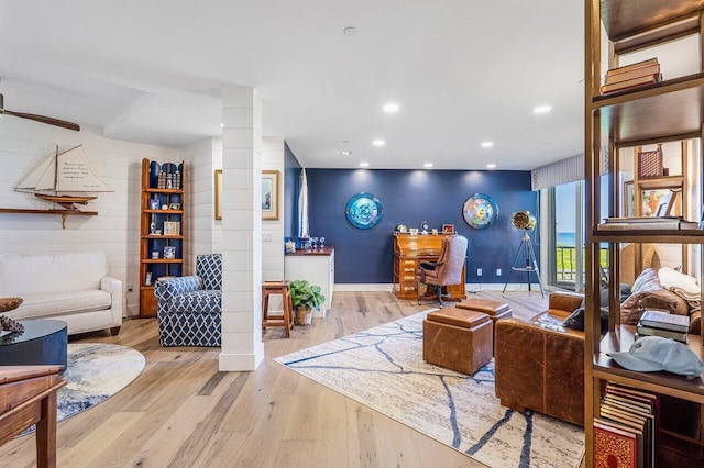 living room featuring ceiling fan and light wood-type flooring