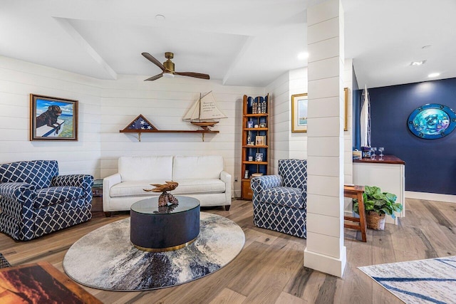 living room with ceiling fan and light hardwood / wood-style flooring