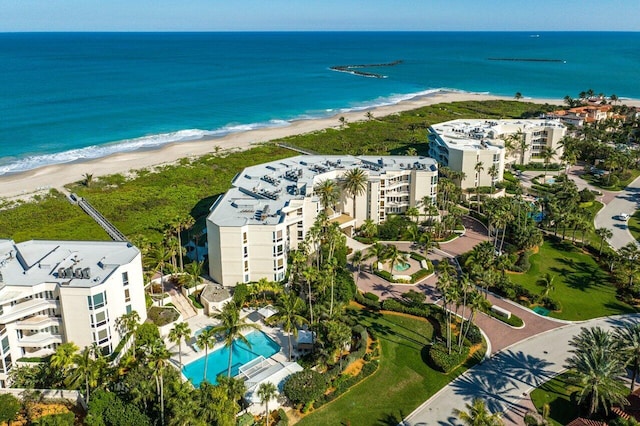 birds eye view of property with a view of the beach and a water view