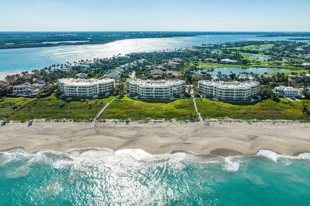 bird's eye view with a water view and a beach view