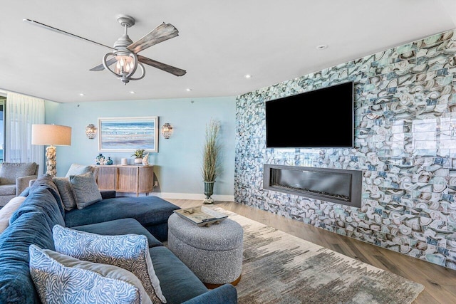 living room with plenty of natural light, ceiling fan, and hardwood / wood-style flooring