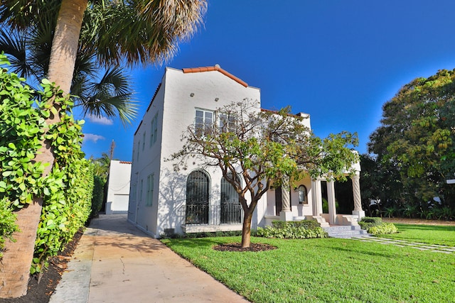 mediterranean / spanish house with a front yard