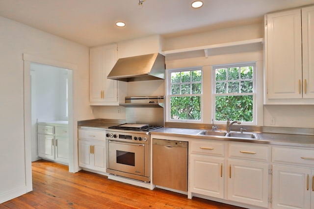 kitchen with sink, white cabinets, stainless steel appliances, and ventilation hood