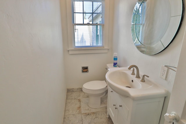 bathroom featuring toilet and vanity