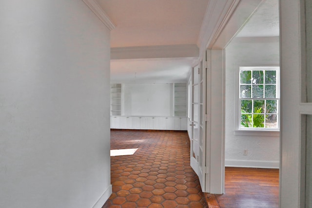 hall with crown molding and built in shelves