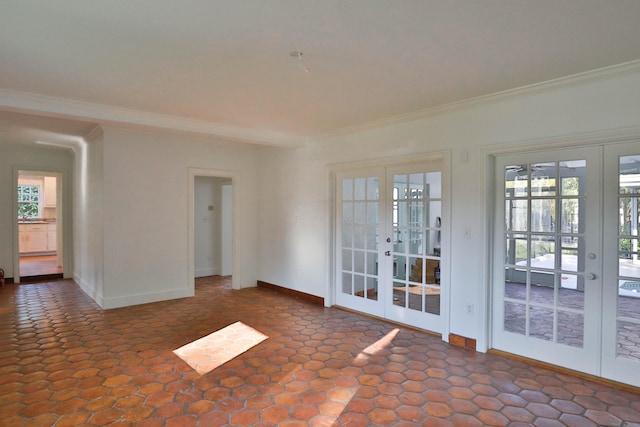 empty room with ornamental molding and french doors