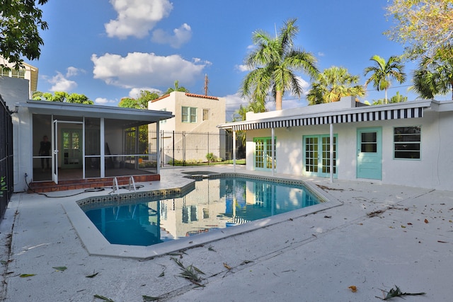 view of pool featuring a sunroom and a patio area