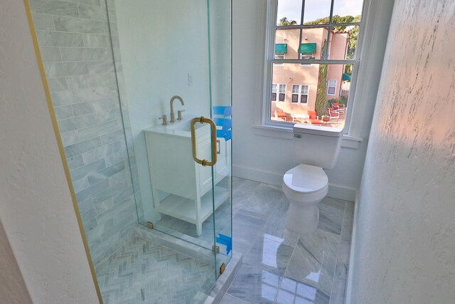 bathroom with toilet, walk in shower, and plenty of natural light