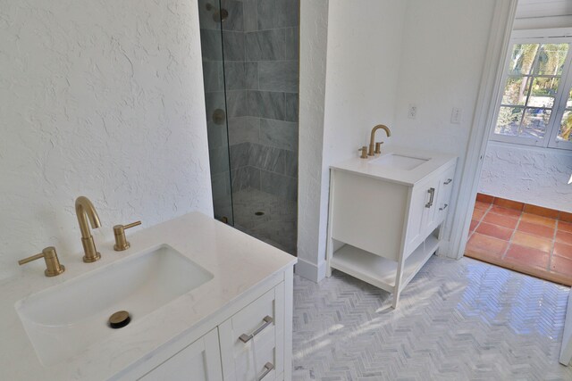 bathroom with vanity and tiled shower